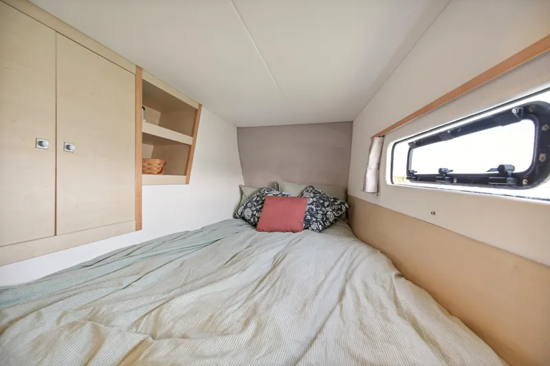 Slide: The Image of Cozy bedroom in 2016 Catana 42 catamaran with window and storage shelves. - 29