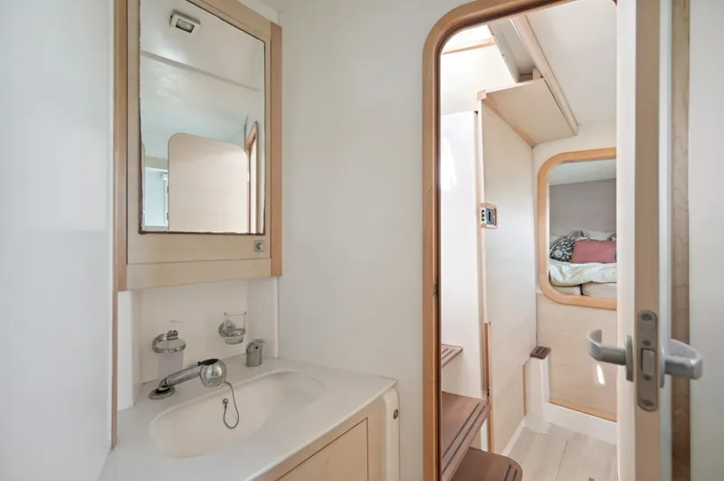 Slide: The Image of Interior of 2016 Catana 42 catamaran featuring bathroom and cozy cabin. - 36