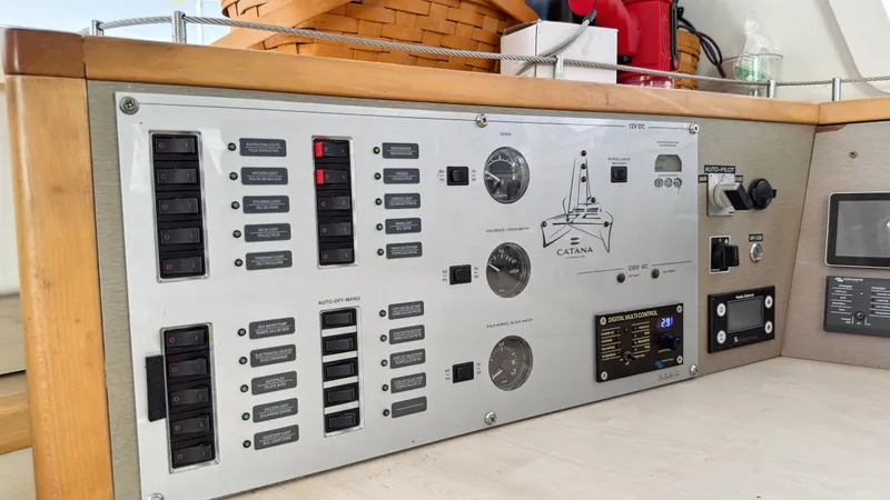 Slide: The Image of Control panel of a 2016 Catana 42 catamaran, featuring switches and gauges. - 49