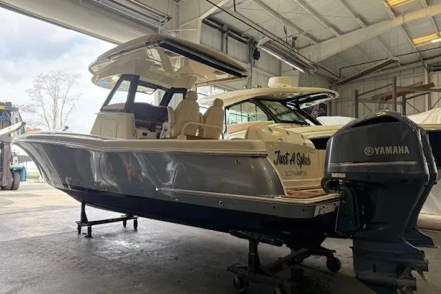 The Image of 2019 Chris-Craft Catalina 30 boat in a warehouse with Yamaha outboard motor. - 0