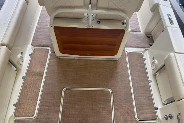 Slide: The Image of 2019 Chris-Craft Catalina 30 interior with beige seating and wood accents. - 10
