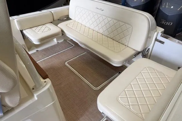 Slide: The Image of 2019 Chris-Craft Catalina 30 interior with elegant white seating and diamond stitching. - 11