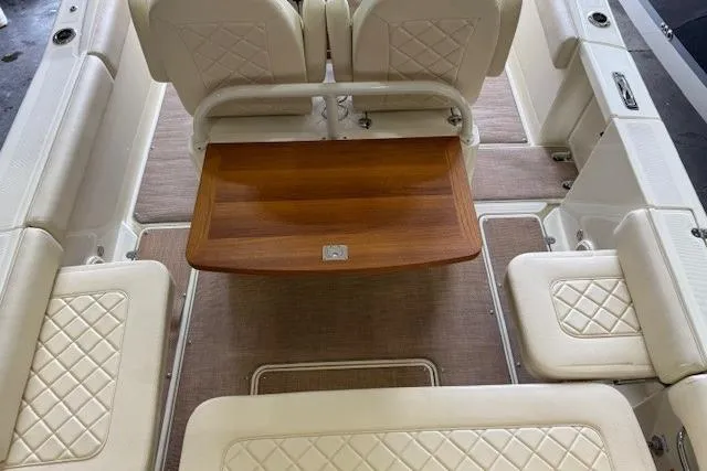 Slide: The Image of 2019 Chris-Craft Catalina 30 interior with elegant seating and wooden table. - 12