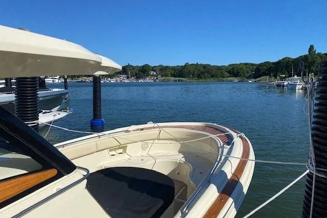 Slide: The Image of 2019 Chris-Craft Catalina 30 boat docked on a serene lake with lush greenery. - 23