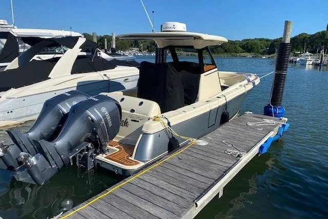 Slide: The Image of 2019 Chris-Craft Catalina 30 docked, featuring dual outboard engines and sleek design. - 24