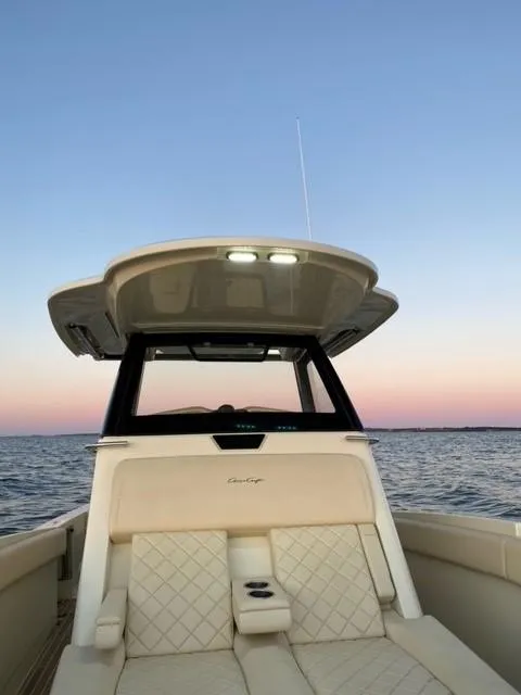 Slide: The Image of 2018 Chris-Craft Catalina 30 boat on calm water at sunset. - 25