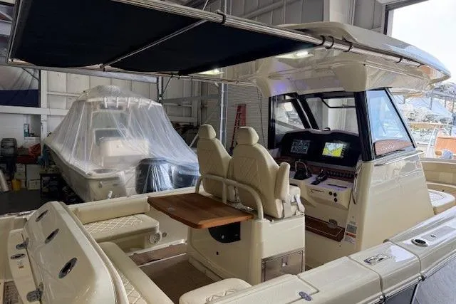Slide: The Image of 2019 Chris-Craft Catalina 30 boat interior with seating and control panel in a storage facility. - 6