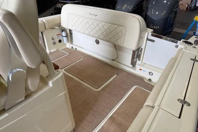 Slide: The Image of 2019 Chris-Craft Catalina 30 interior with beige seating and carpeted flooring. - 9