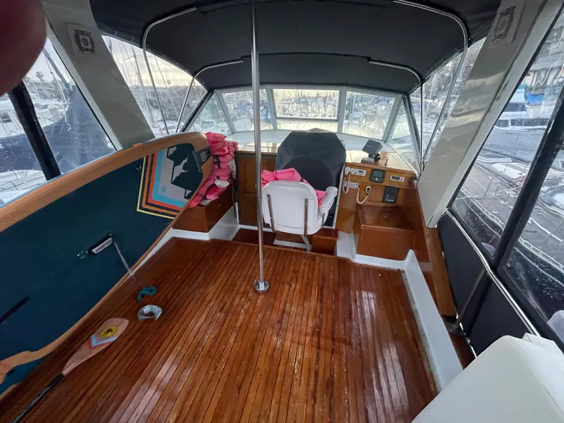 Slide: The Image of 1968 Chris-Craft Commander boat interior with wooden flooring and helm station. - 11