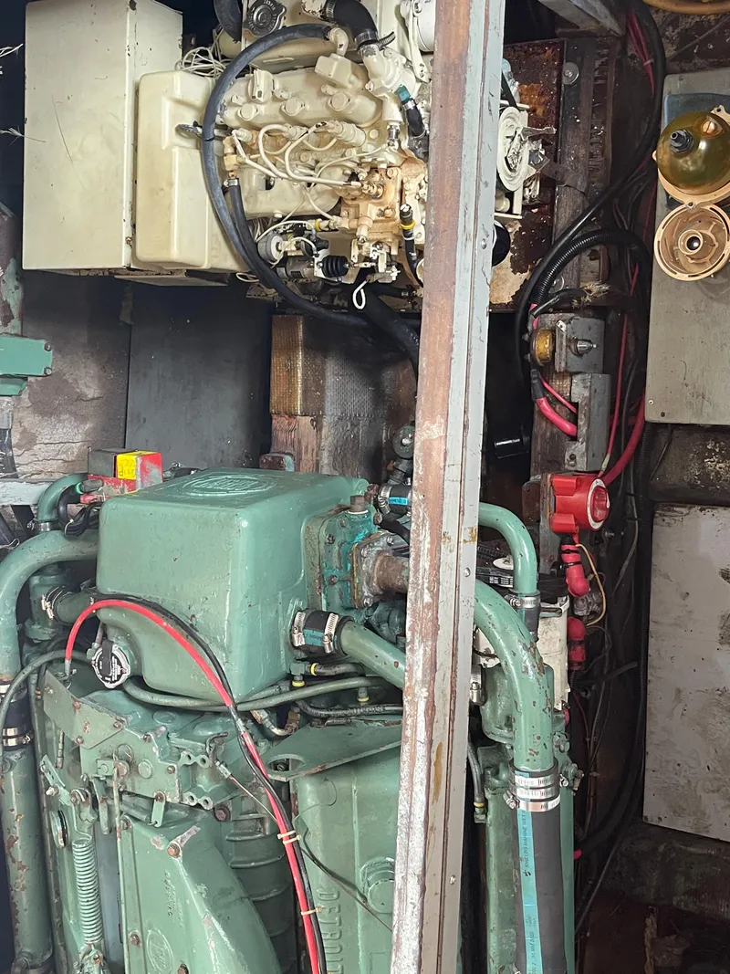 Slide: The Image of Engine room of a 1968 Chris-Craft Commander boat with visible machinery and wiring. - 18