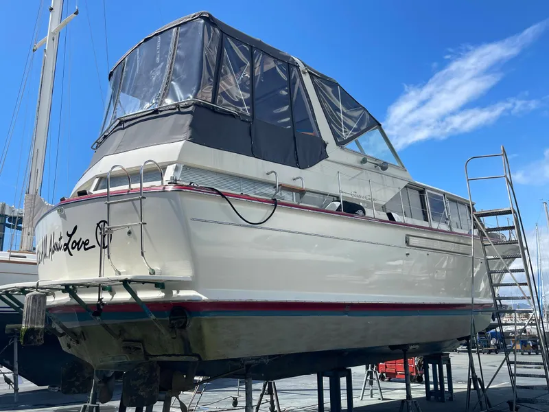 Slide: The Image of 1968 Chris-Craft Commander boat on dry dock under a clear blue sky. - 23