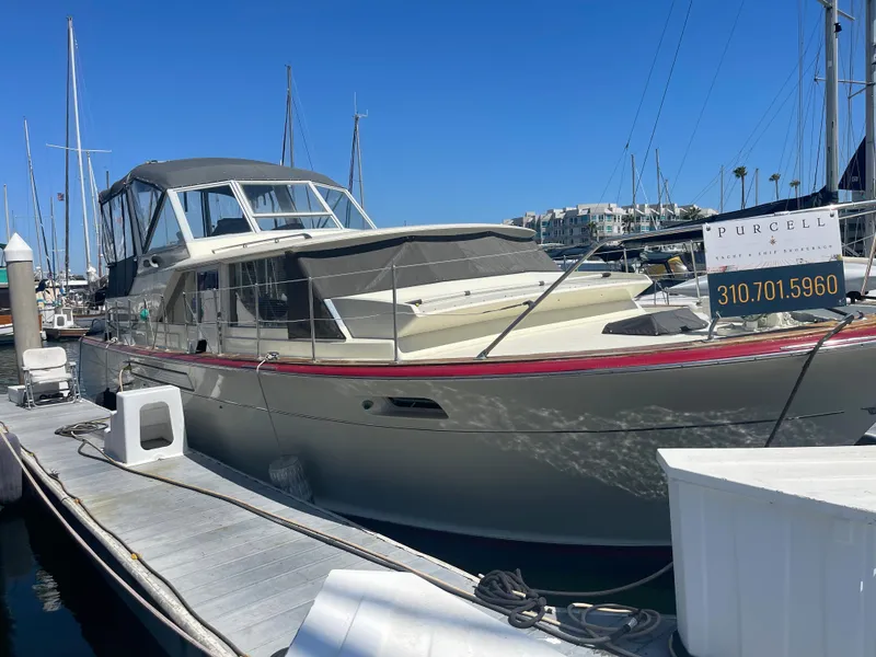 Slide: The Image of 1968 Chris-Craft Commander yacht docked at marina under clear blue sky. - 27