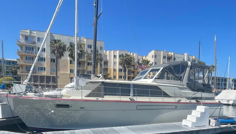 Slide: The Image of 1968 Chris-Craft Commander yacht docked at marina with modern buildings in background. - 30
