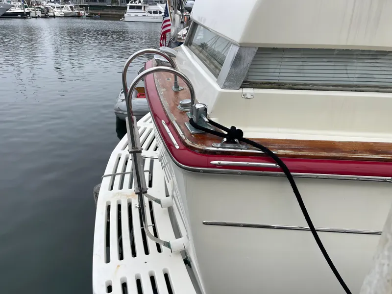 Slide: The Image of 1968 Chris-Craft Commander yacht docked, featuring classic design and wooden accents. - 4