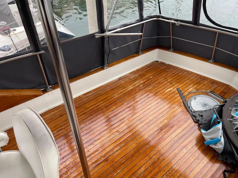 Slide: The Image of 1968 Chris-Craft Commander boat interior with polished wooden deck and seating area. - 6