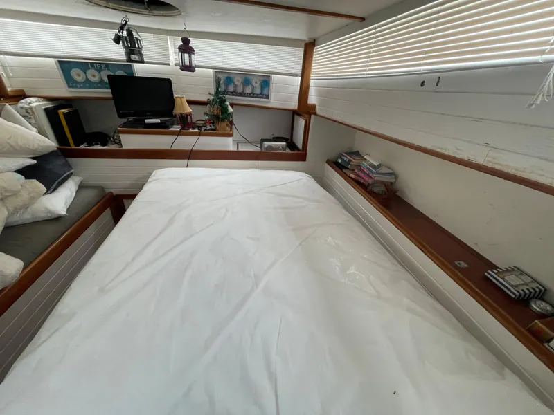 Slide: The Image of 1968 Chris-Craft Commander interior with bed, TV, and decor elements. - 8