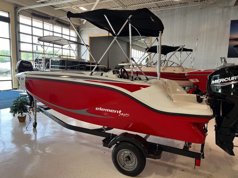 Slide: The Image of 2023 Bayliner Element M15 boat in showroom, red and white design, with Mercury outboard motor. - 14