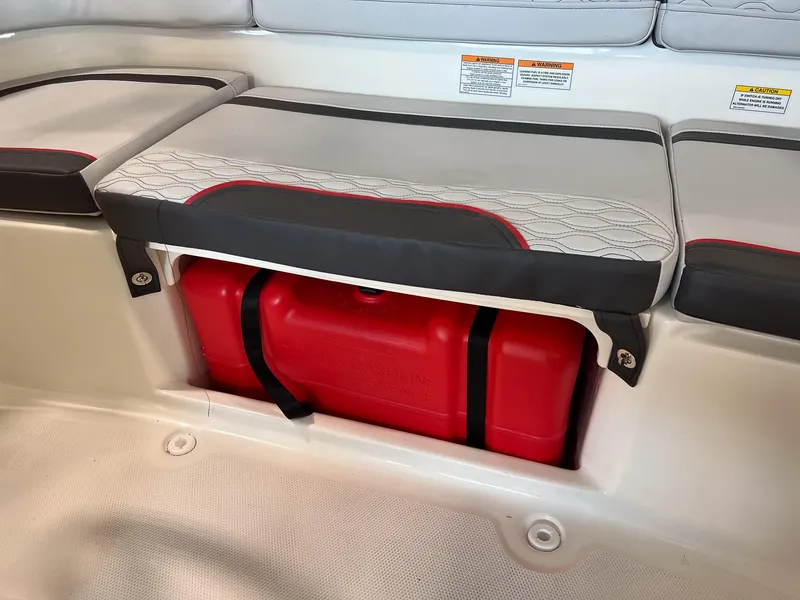 Slide: The Image of Bayliner Element M15 2023 boat seat storage with red gasoline tank. - 18