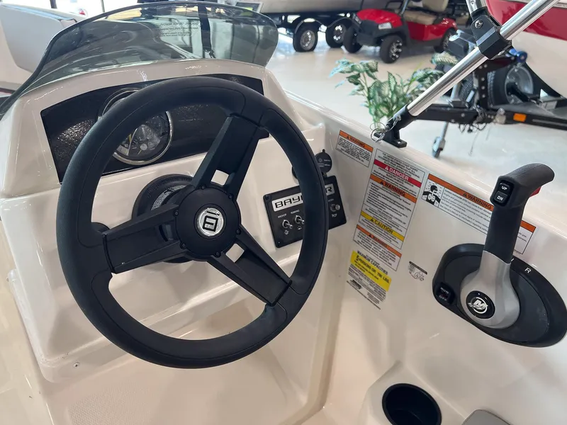 Slide: The Image of 2023 Bayliner Element M15 boat steering wheel and control panel. - 19