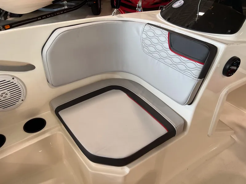 Slide: The Image of 2023 Bayliner Element M15 boat interior seating with cup holders and speaker. - 22