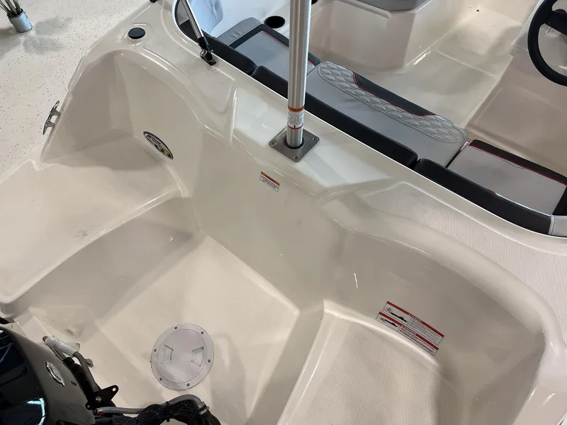 Slide: The Image of 2023 Bayliner Element M15 boat interior, showing seating and storage area. - 3