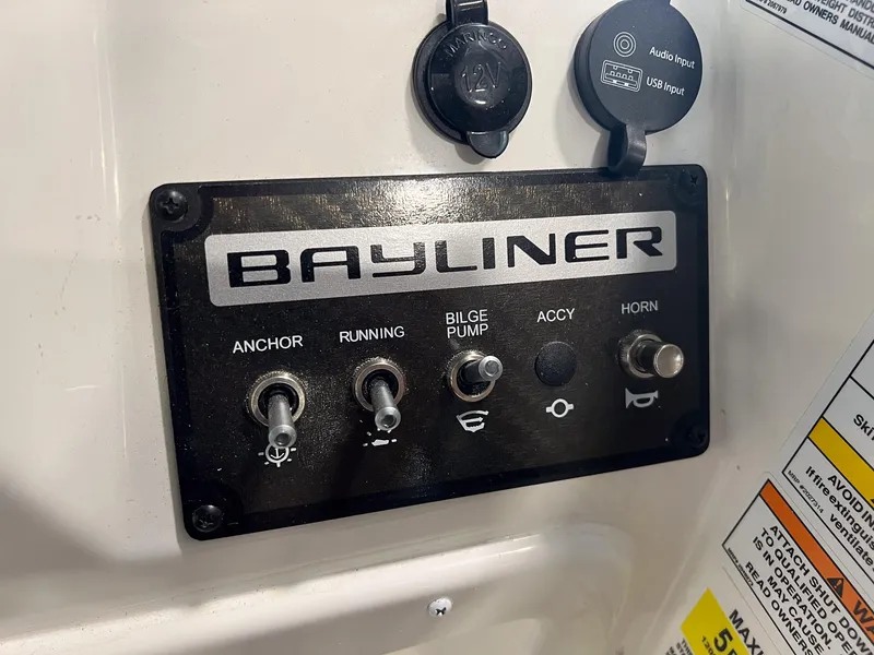 Slide: The Image of Control panel of a 2023 Bayliner Element M15 boat with various switches. - 5