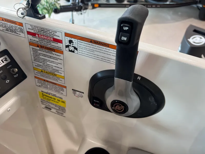 Slide: The Image of Close-up of 2023 Bayliner Element M15 boat control panel and throttle. - 6