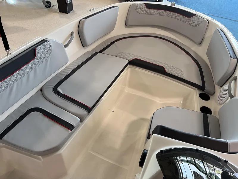 Slide: The Image of 2023 Bayliner Element M15 boat interior with cushioned seating and cup holders. - 7
