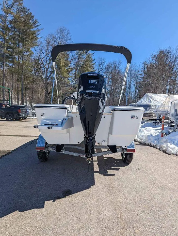 Slide: The Image of 2023 Sundance DX20 boat with outboard motor on trailer in sunny outdoor setting. - 13