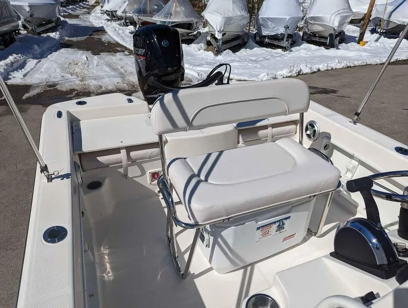 Slide: The Image of 2023 Sundance DX20 boat with white seating and Mercury outboard motor. - 14