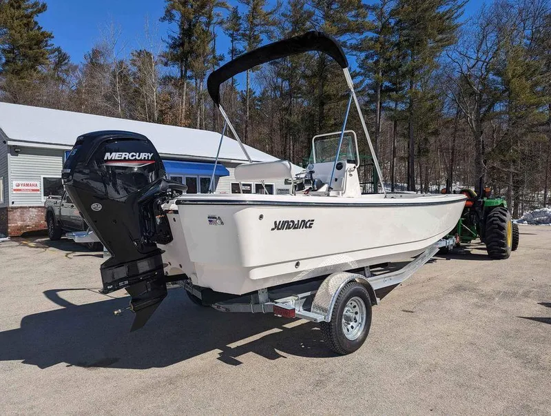 Slide: The Image of 2023 Sundance DX20 boat with Mercury outboard motor on a trailer. - 3