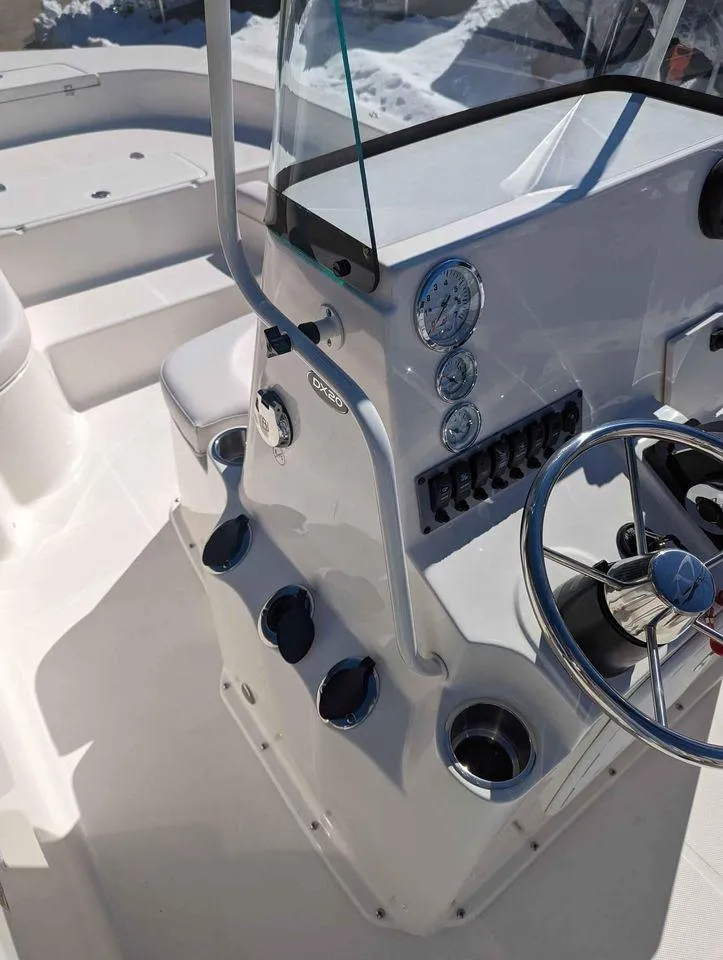 Slide: The Image of 2023 Sundance DX20 boat console with steering wheel and instrument panel. - 5
