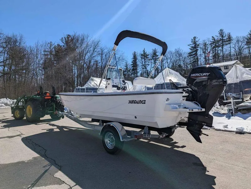 Slide: The Image of 2023 Sundance DX20 boat on trailer with Mercury outboard motor. - 6