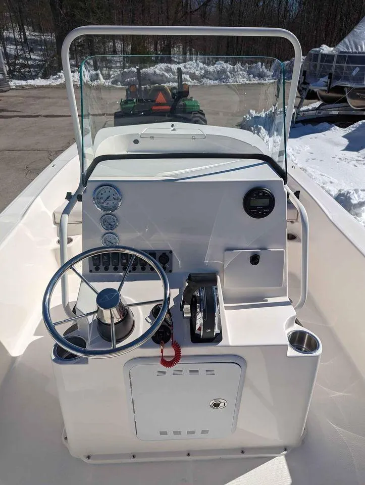 Slide: The Image of 2023 Sundance DX20 boat console with steering wheel and controls. - 8