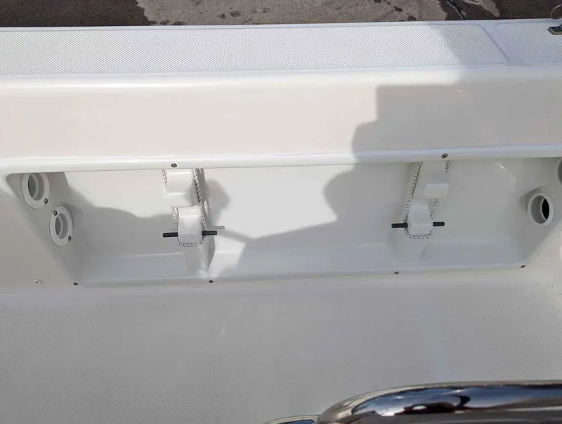 Slide: The Image of 2023 Sundance DX22 boat interior compartment with white straps and mounting points. - 14