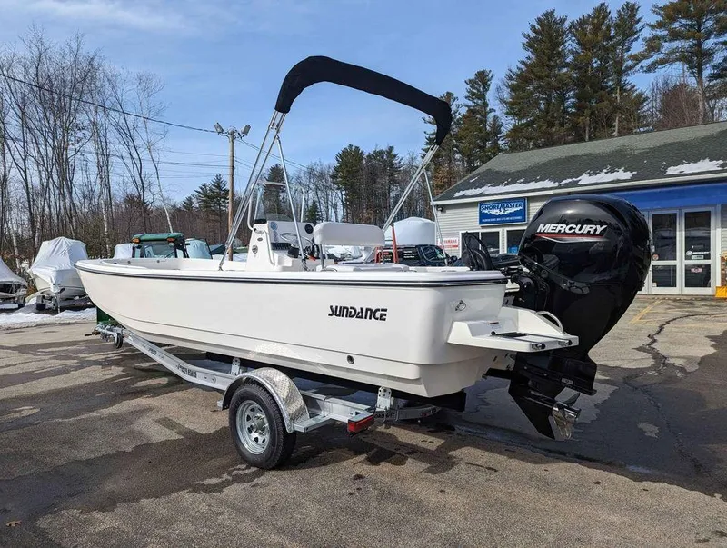 Slide: The Image of 2023 Sundance DX22 boat with Mercury outboard motor on trailer. - 2