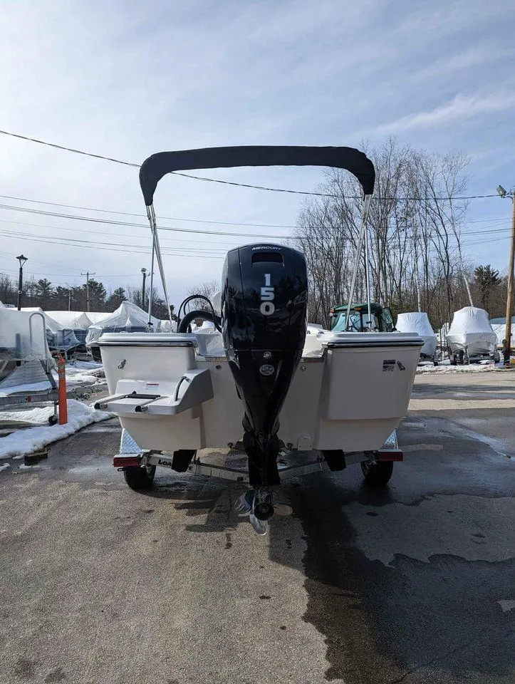 Slide: The Image of 2023 Sundance DX22 boat with 150 HP outboard motor, rear view. - 3