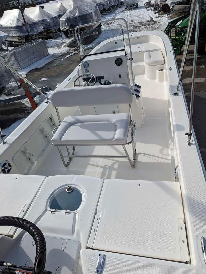 Slide: The Image of 2023 Sundance DX22 boat interior with seating and steering console. - 5