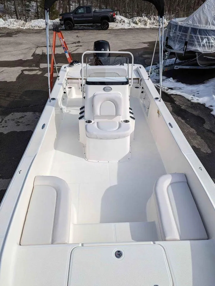 Slide: The Image of 2023 Sundance DX22 boat with white interior and seating. - 6