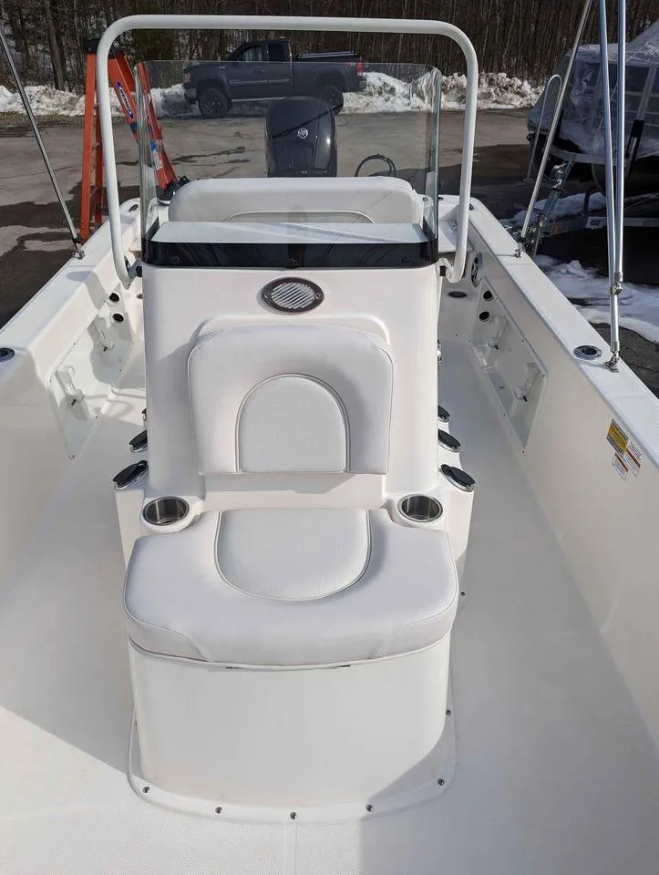 Slide: The Image of 2023 Sundance DX22 boat with white seating and console. - 7