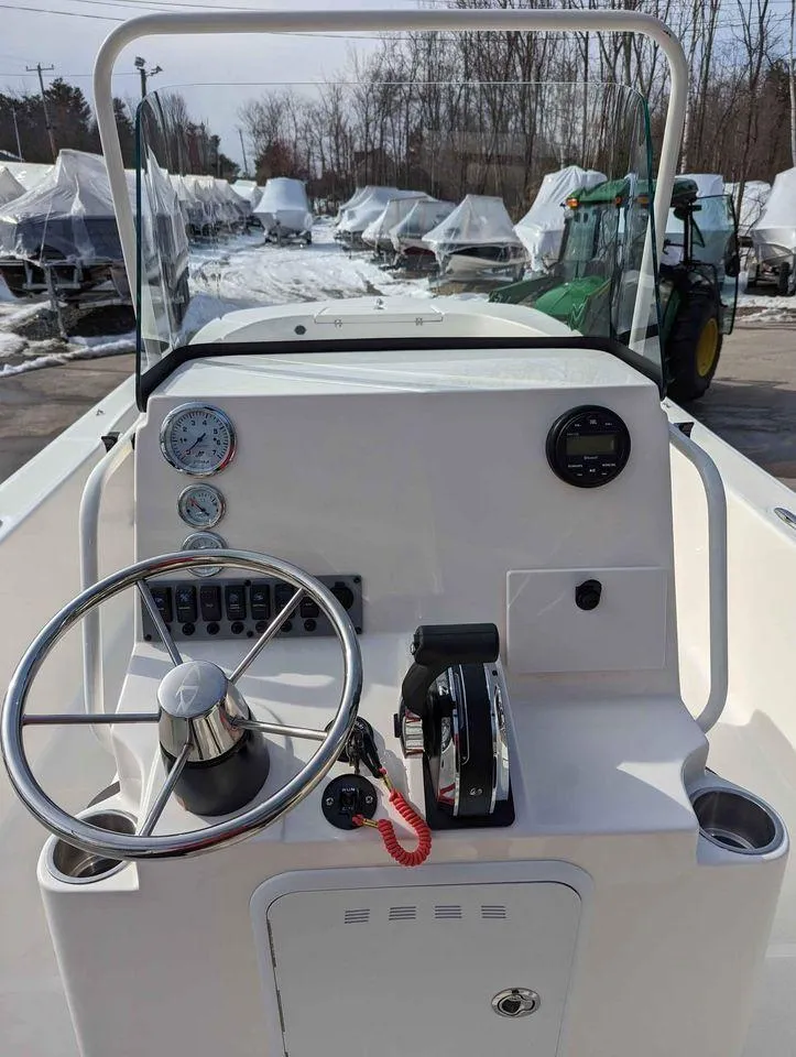 Slide: The Image of 2023 Sundance DX22 boat dashboard with steering wheel and controls. - 9