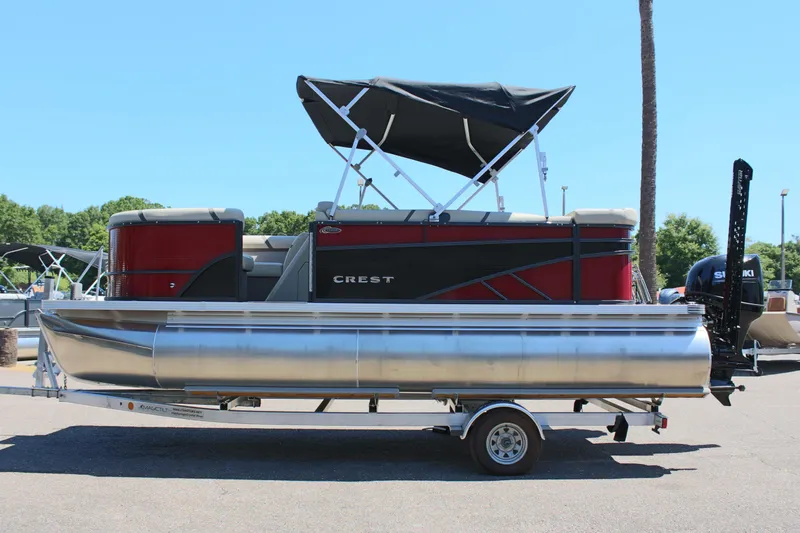 The Image of 2023 Crest Classic 200 LX L pontoon boat with black canopy on trailer. - 0