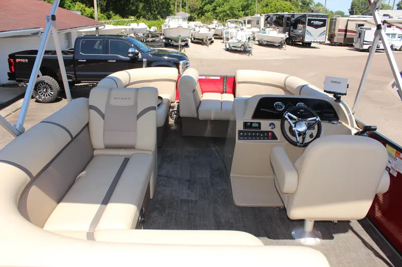 Slide: The Image of 2023 Crest Classic 200 LX L pontoon boat interior with beige seating and modern dashboard. - 11