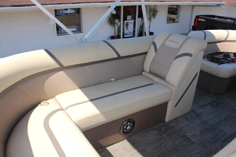 Slide: The Image of 2023 Crest Classic 200 LX L boat interior with beige seating and speaker. - 14