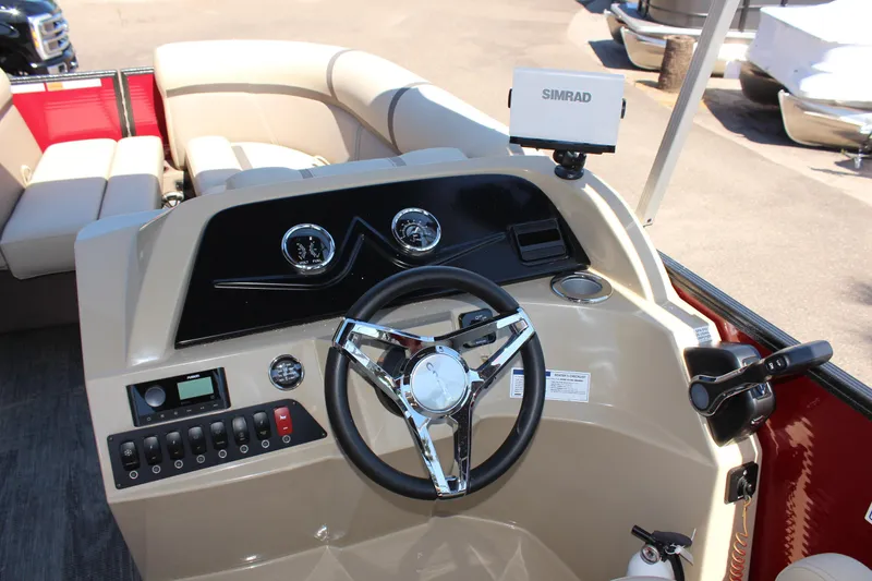 Slide: The Image of 2023 Crest Classic 200 LX L boat dashboard with steering wheel and Simrad display. - 17