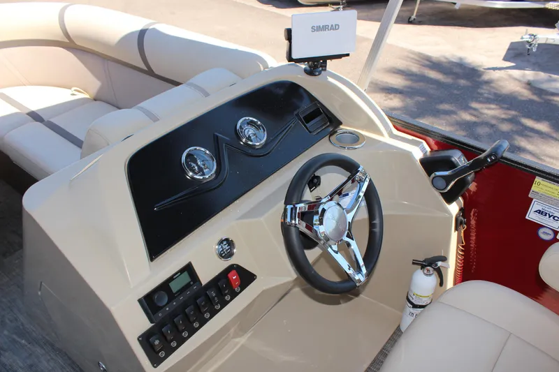 Slide: The Image of 2023 Crest Classic 200 LX L boat dashboard with steering wheel and control panel. - 18