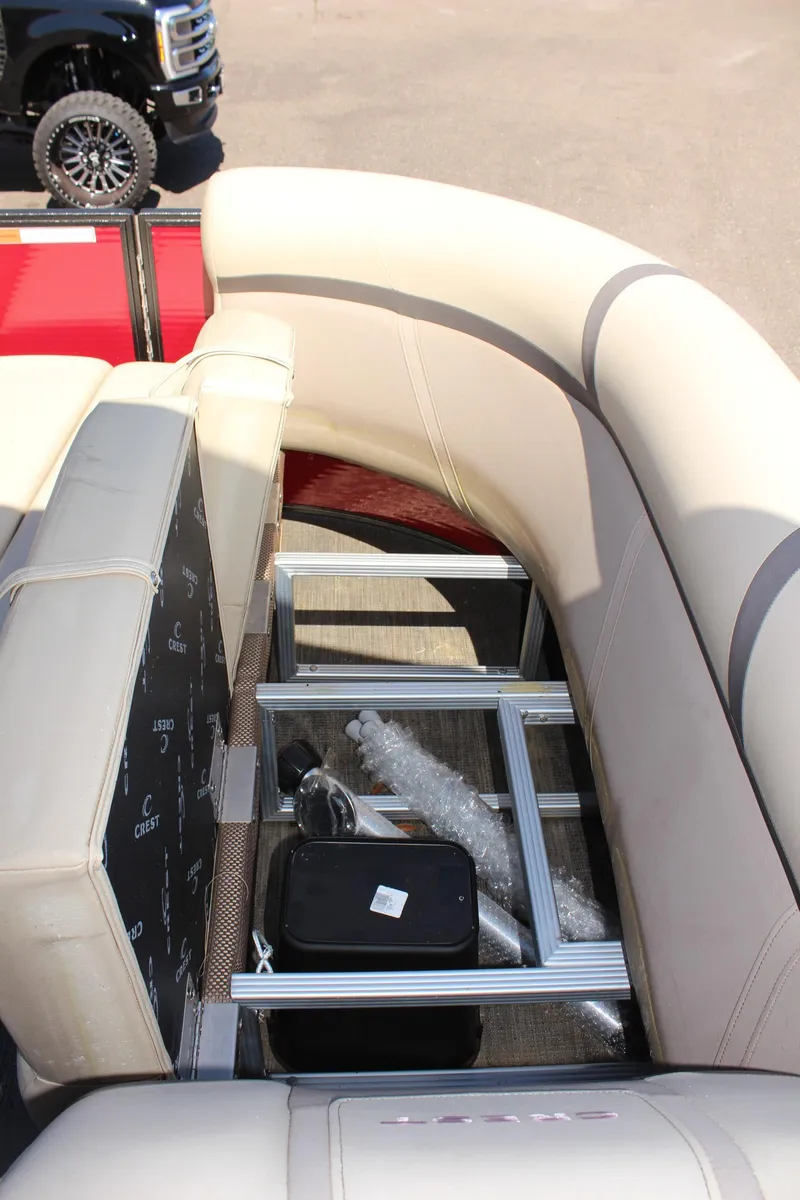 Slide: The Image of 2023 Crest Classic 200 LX L pontoon boat interior with storage compartments. - 23