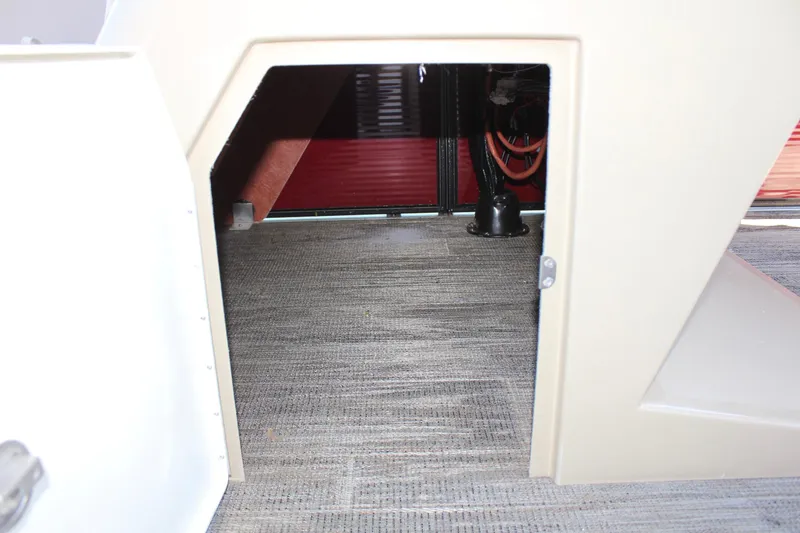 Slide: The Image of 2023 Crest Classic 200 LX L storage compartment with carpeted interior. - 27