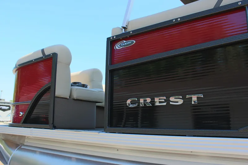 Slide: The Image of 2023 Crest Classic 200 LX L pontoon boat with red and black exterior. - 8