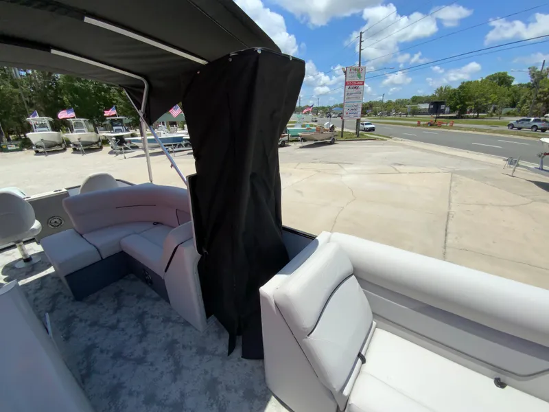 Slide: The Image of 2023 Crest Classic LX 220 SF pontoon boat interior with seating and canopy. - 14